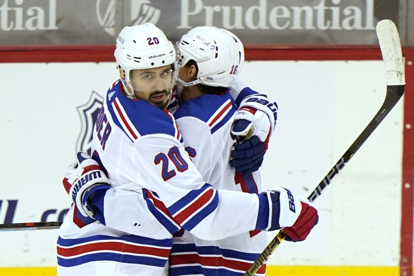 New York Rangers left wing Chris Kreider (20) embraces New York Rangers center Ryan Strome (16) after scoring a goal during the first period of an NHL hockey game against the New Jersey Devils, Thursday, March 4, 2021, in Newark, N.J. (AP Photo/Kathy Willens)