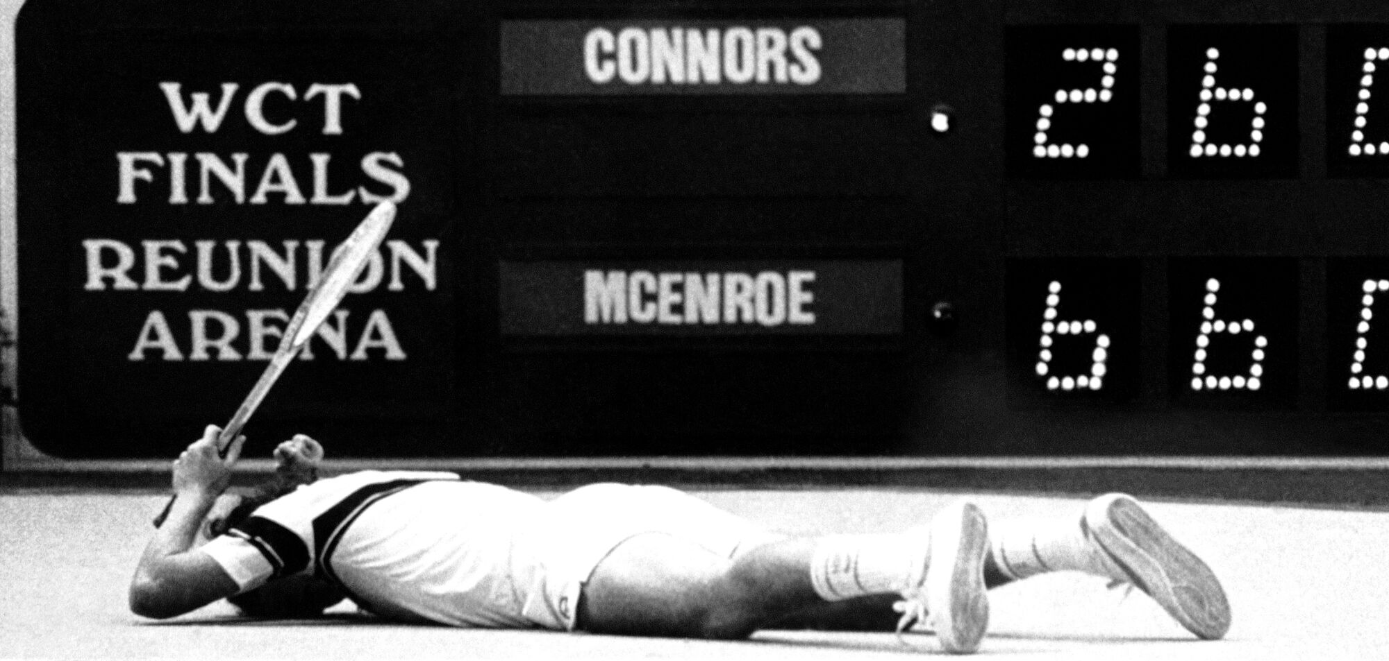 Tennis star John McEnroe lies face down on the court after missing a volley in Dallas in 1980.