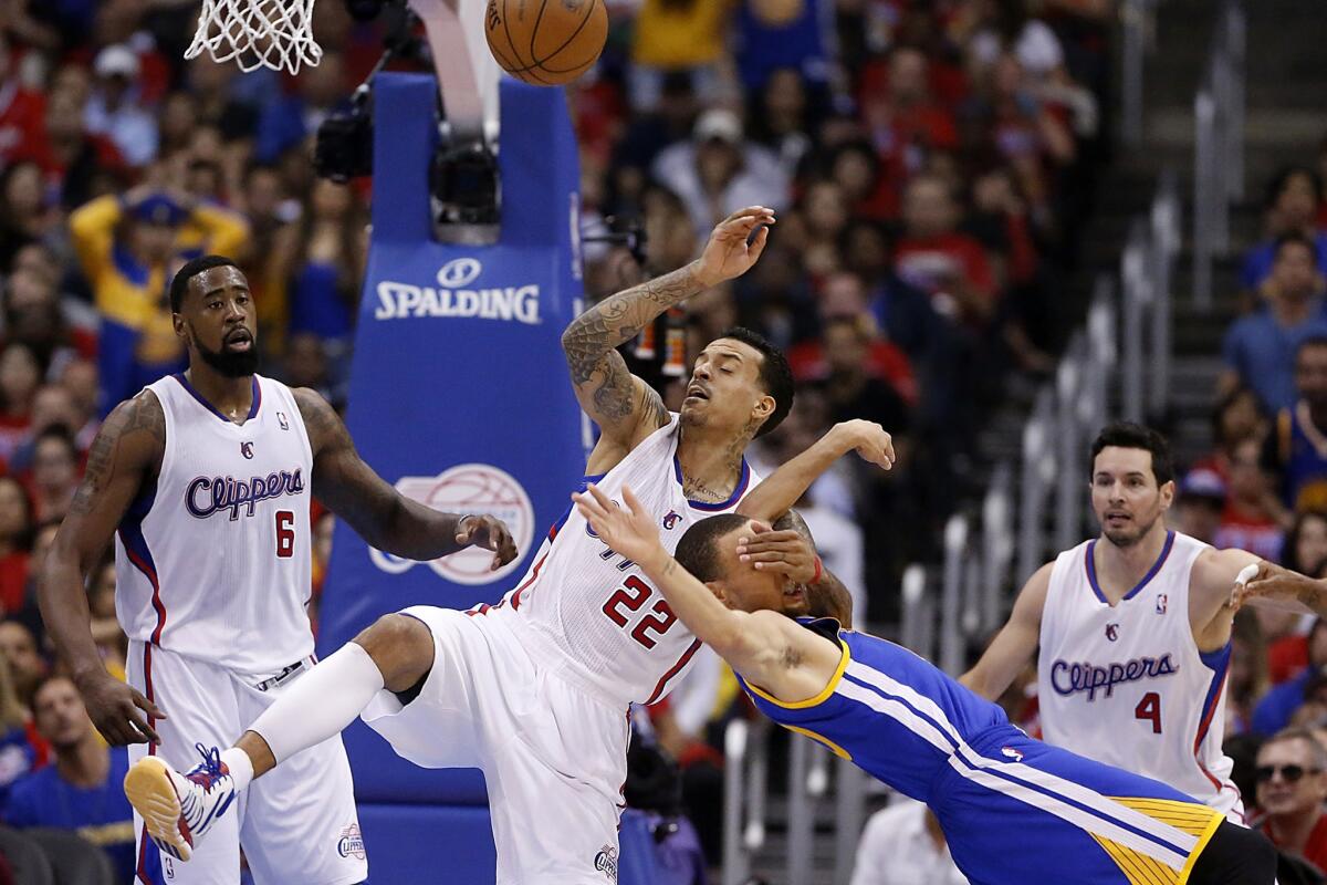 Clippers forward Matt Barnes gets tangled with Warriors point guard Stephen Curry after fouling him.