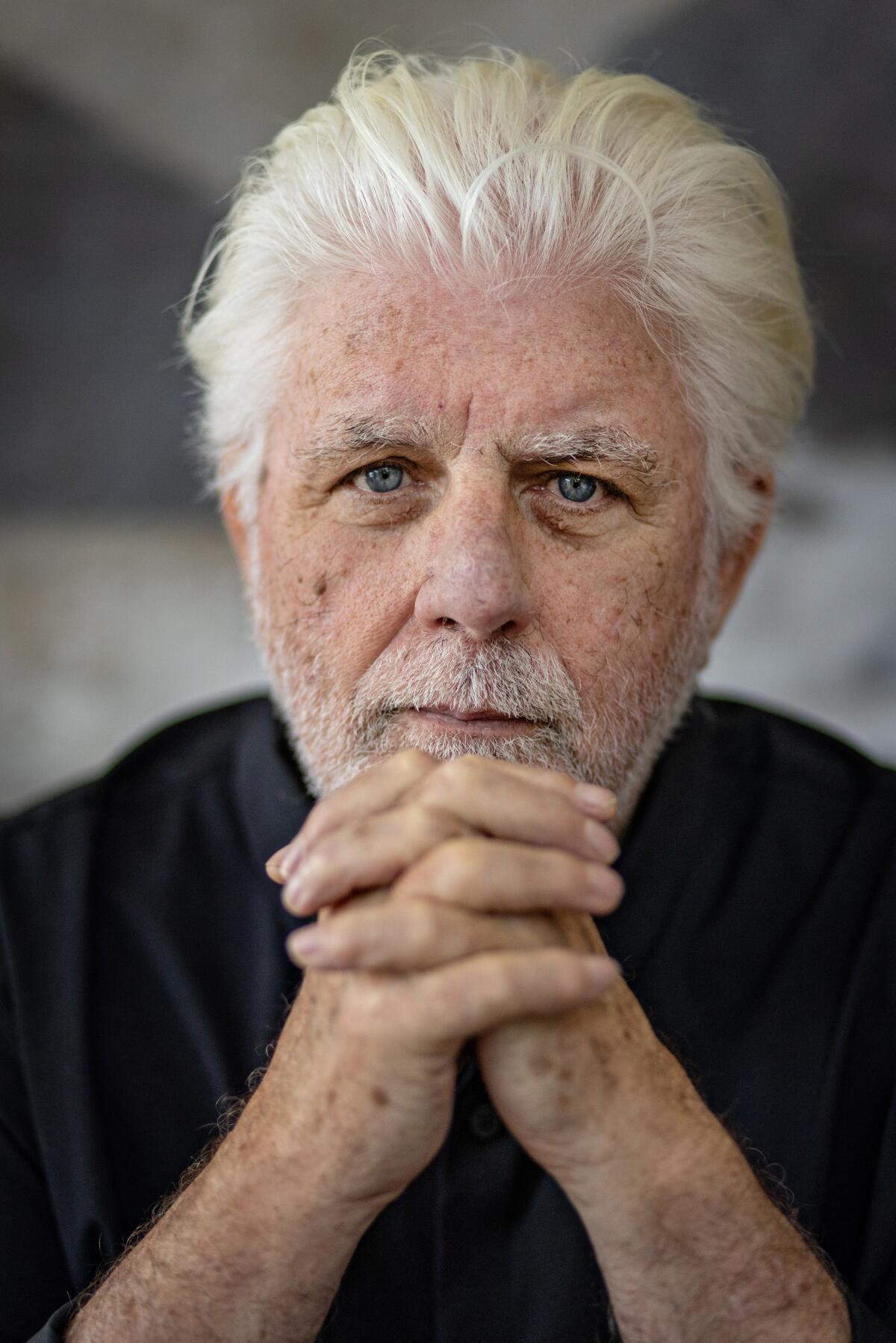 Michael McDonald with his hands clasped in front of his chin