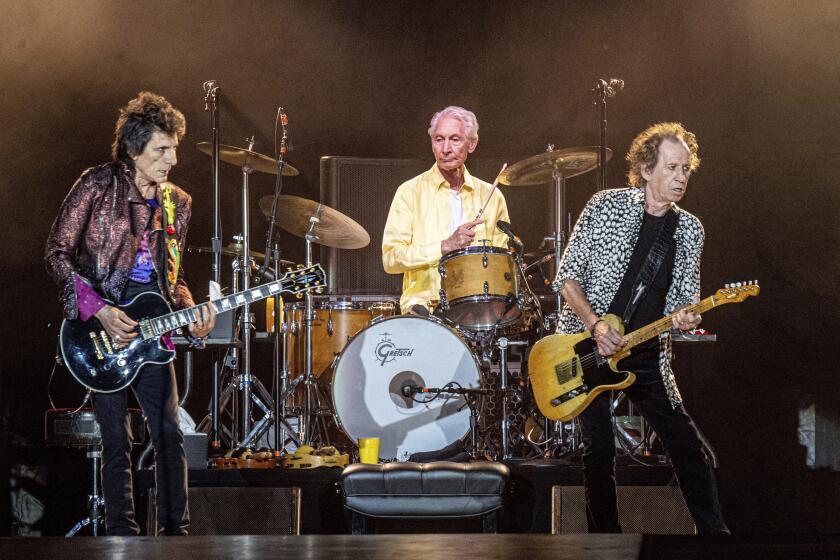 FILE - Ronnie Wood, from left, Charlie Watts and Keith Richards of The Rolling Stones perform on July 15, 2019, in New Orleans. Watts' publicist, Bernard Doherty, said Watts passed away peacefully in a London hospital surrounded by his family on Tuesday, Aug. 24, 2021. He was 80. (Photo by Amy Harris/Invision/AP, File)