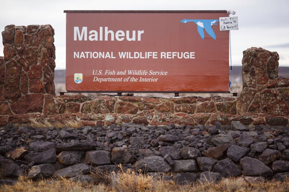 In protest, a mop and sign reading, "Make the militia to go home," were attached to a sign at the occupied Malheur National Wildlife Refuge outside Burns, Ore.