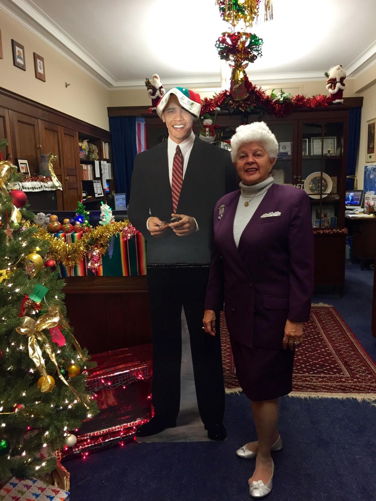 Rep. Grace Napolitano (D-Norwalk) shows off Christmas decorations in her office. She said staff and visitors stop in to have their photo taken with the cutout of President Obama in a Santa hat.