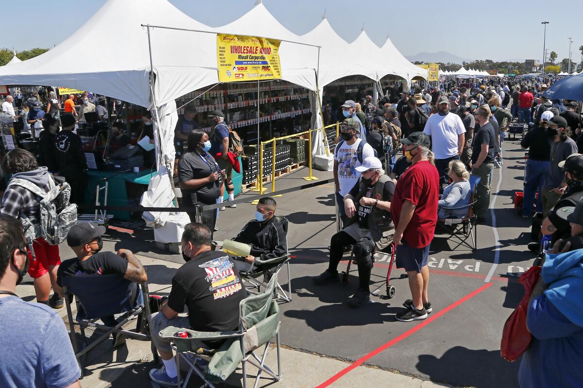 Customers wait in line to buy ammo during Crossroads of the West Gun Show on March 27, 2020.