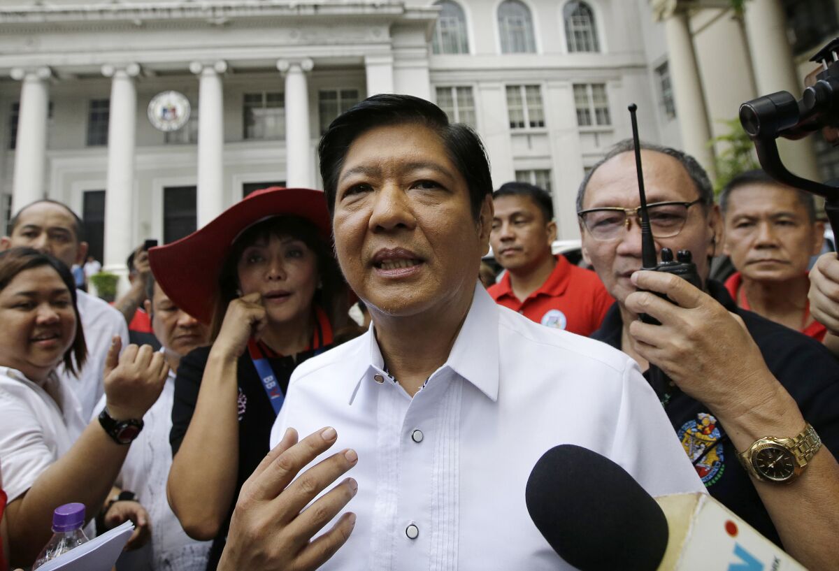FILE - In this April 2, 2018, file photo, former Senator Ferdinand "Bongbong" Marcos Jr. talks to reporters in front of the Philippine Supreme Court in Manila, Philippines. Marcos Jr., the son and namesake of the late Philippine dictator Ferdinand Marcos, who was toppled in a 1986 revolt, announced Tuesday, Oct. 5, 2021, that he would seek the presidency in next year's elections in what activists say is an attempt to whitewash a dark period in the country's history marked by plunder and human rights atrocities. (AP Photo/Aaron Favila, File)
