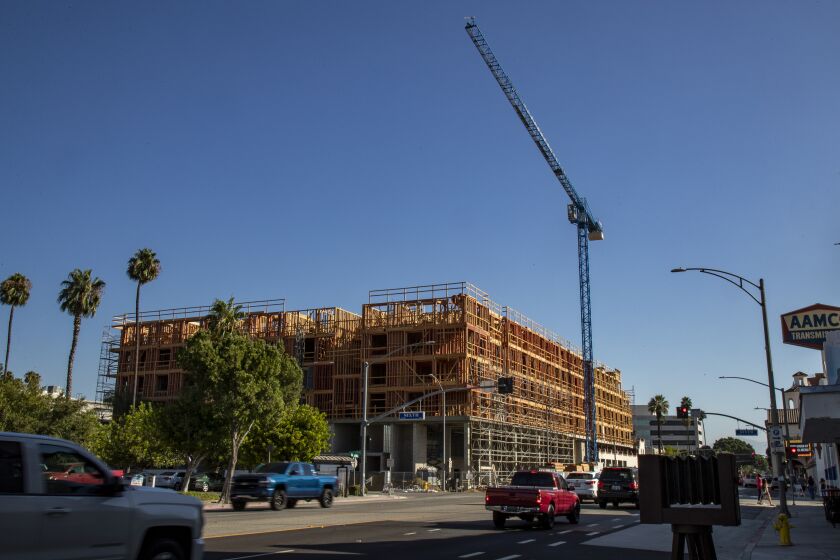 RIVERSIDE CA - AUGUST 6, 2020: Construction is underway for Mark Riverside, a 22,000 square foot retail space with 165 housing units in downtown Riverside, California. Since Covid hit, developers have been straining to get financial backing for housing projects.(Gina Ferazzi / Los Angeles Times)