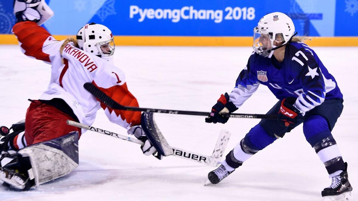 Jocelyne Lamoureux-Davidson, right, scores against OAR's Valeria Tarakanova during a 5-0 preliminary-round victory for the U.S. on Tuesday night at Kwandong Hockey Centre.