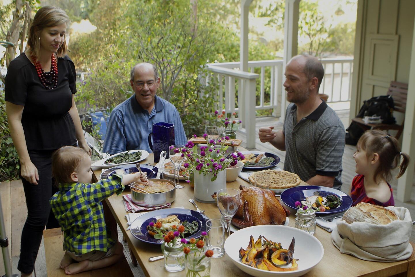 Chefs Karen and Quinn, second from right, Hatfield, children Bennett, left, and Paige, and father-in-law Larry at the table at the Hatfields' Laurel Canyon home.