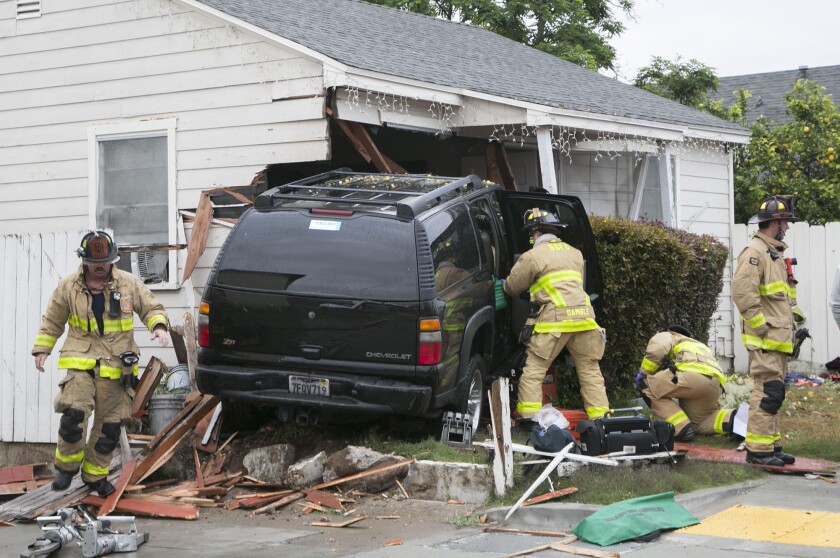 An SUV slammed into a house on Monroe Avenue in San Diego's Talmadge neighborhood on Thursday morning after the driver suffered some kind of a medical emergency while taking his son to school.