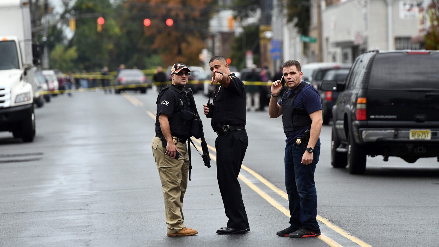 Law inforcement officers secure the area where they allegedly arrested bombing suspect Ahmad Khan Rahami following a shootout in Linden, N.J, on September 19.