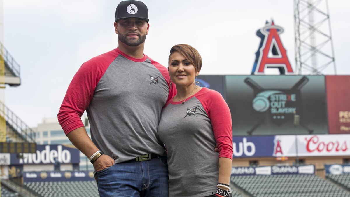 Parade Grand Marshal Albert Pujols stands with wife, Deidre, at Angel Stadium in 2017.