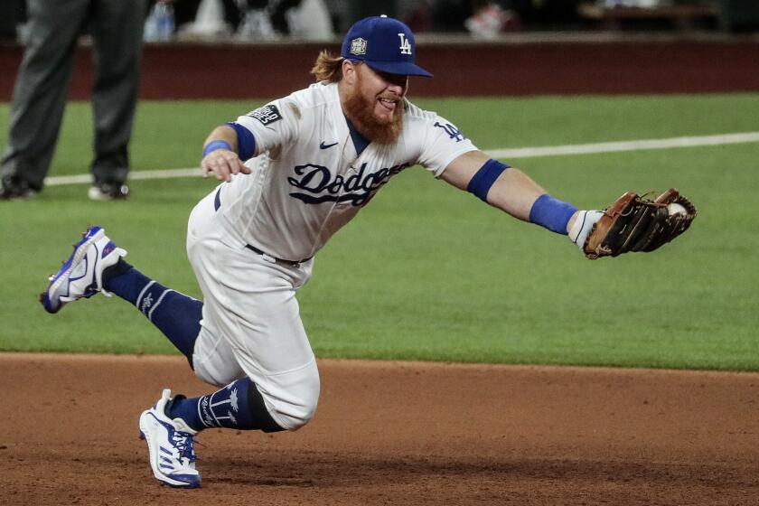 Los Angeles Dodgers third baseman Justin Turner snags a grounder