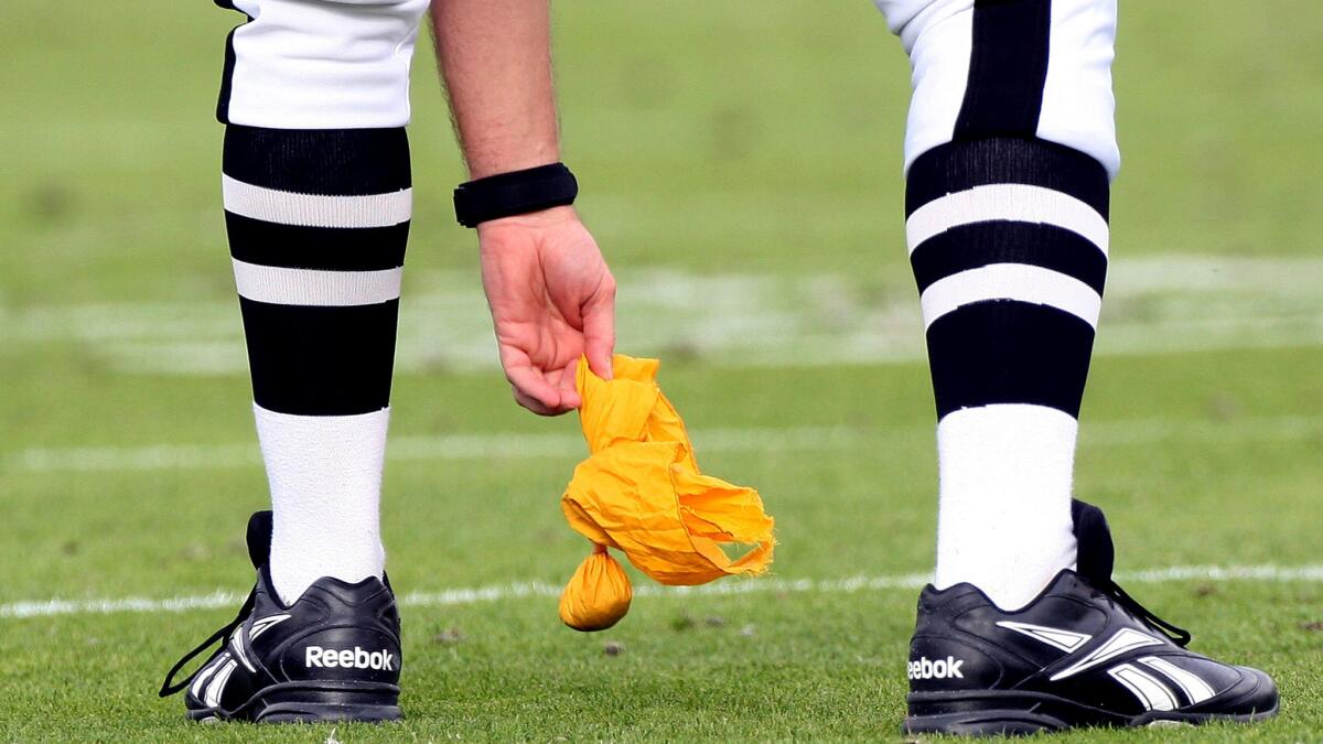 The yellow penalty flags used by NFL officials are now issued by the league.