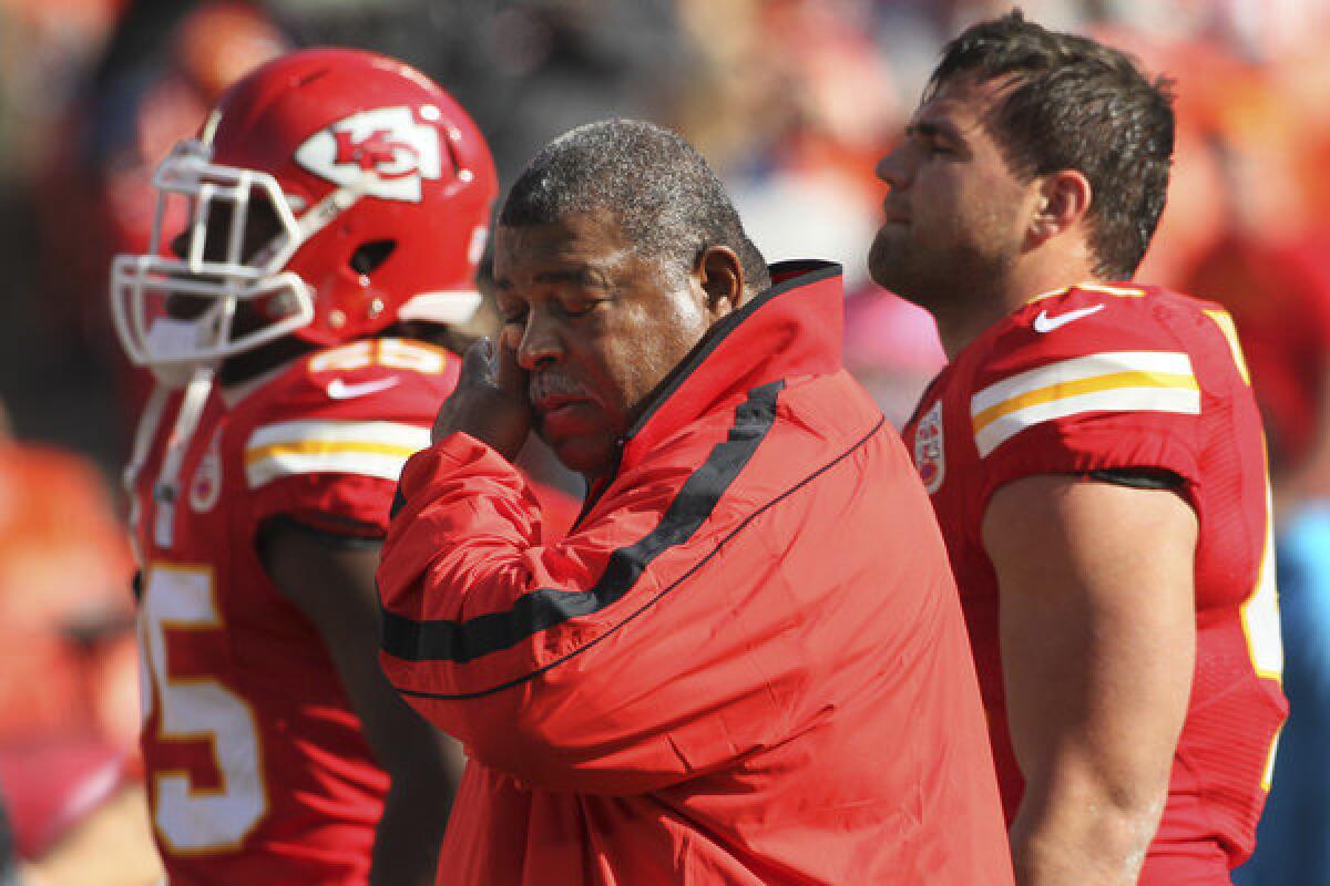 Chiefs Coach Romeo Crennel wipes his eyes during an emotional start to the game against the Panthers on Sunday at Arrowhead Stadium.