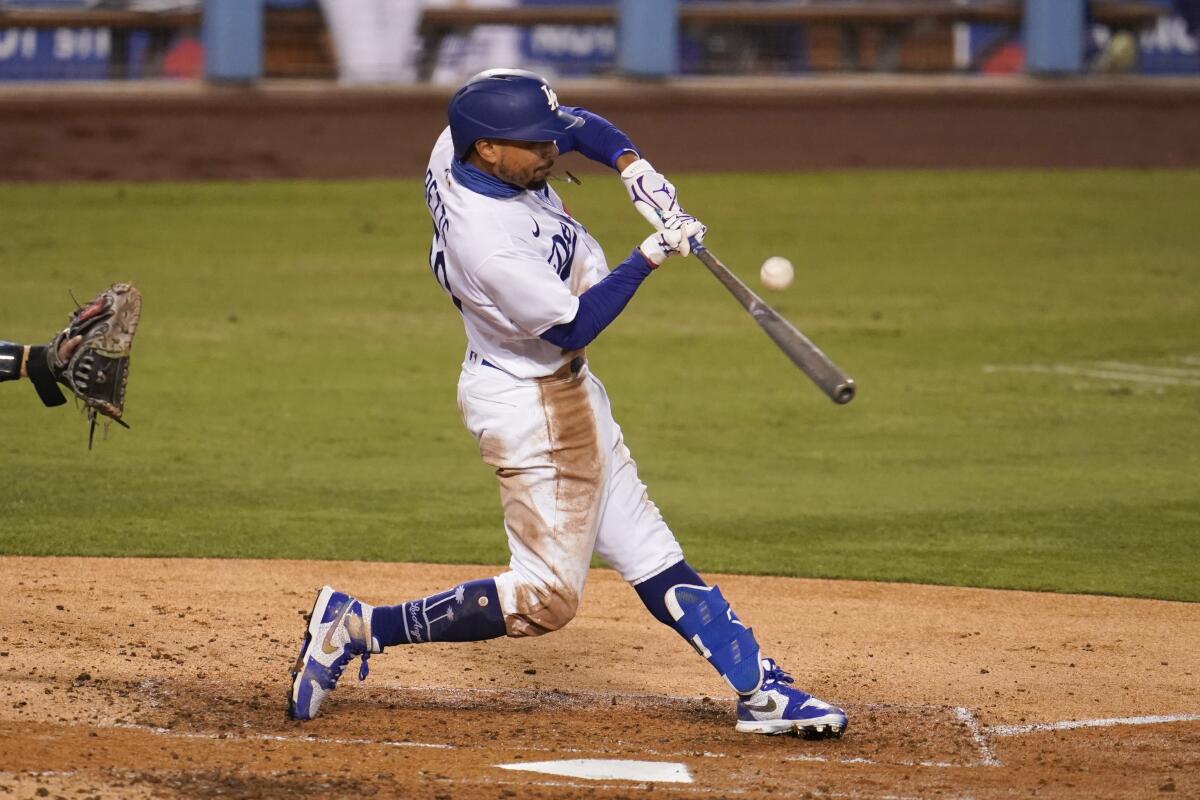 Dodgers right fielder Mookie Betts hits against the Arizona Diamondbacks.
