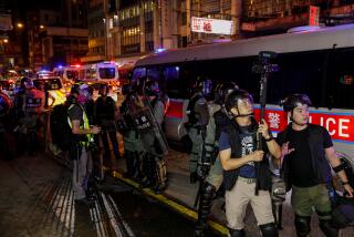HONG KONG, CHINA -- SUNDAY, SEPTEMBER 8, 2019: Hong Kong police record images of protesters and journalists as protests continue in the Mong Kok neighborhood of Hong Kong, on Sept. 8, 2019. (Marcus Yam / Los Angeles Times)