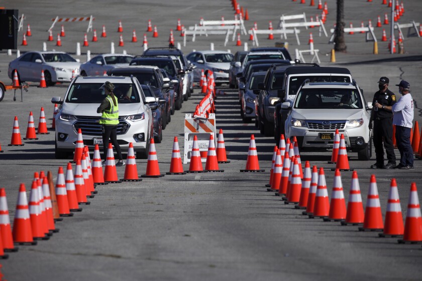 Cars line up amid rows of cones