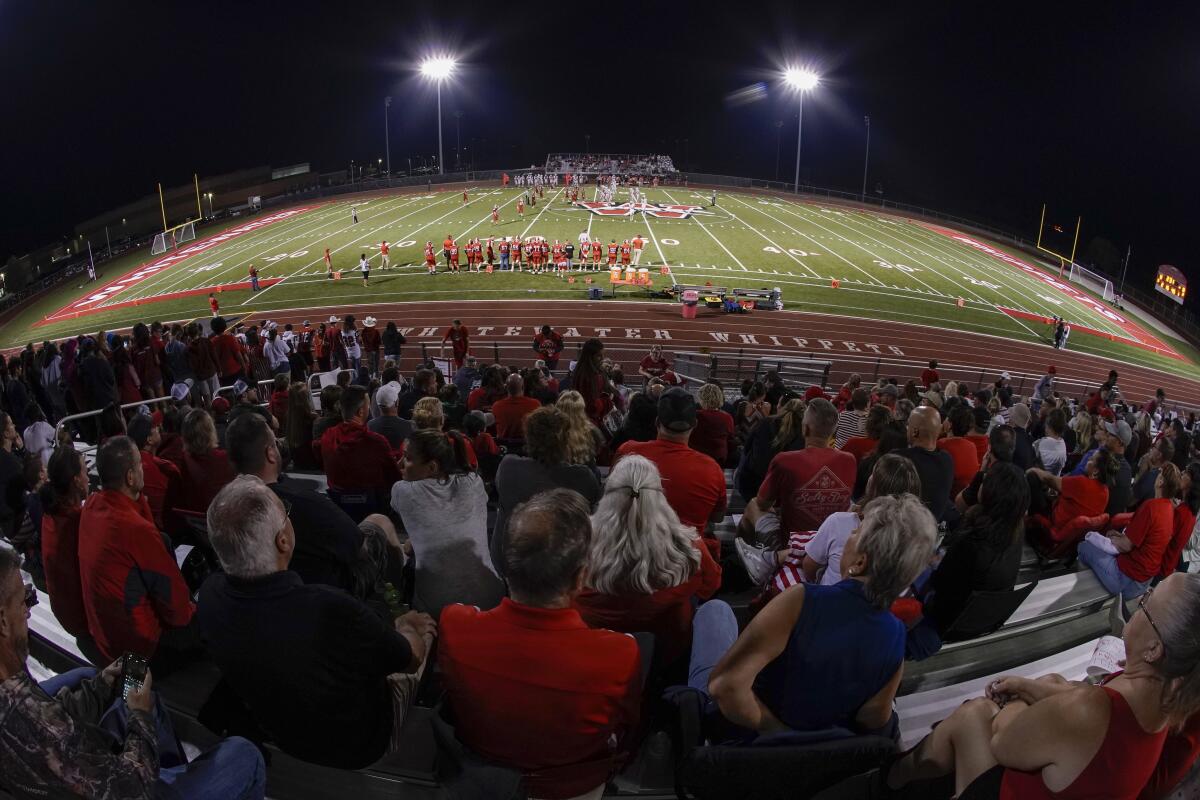 Fans fill the football stadium at Whitewater High School in Whitewater, Wis., on Friday. 