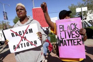 Kiora Hansen and Della Currie, from left, protest during a rally at Antioch police headquarters in Antioch, Calif., on Tuesday, April 18, 2023. The city council of a small San Francisco Bay Area city voted Tuesday to launch three audits of its troubled Antioch Police Department, the latest development in a year-long federal investigation of the police force that blew up this month with the disclosure of racist text messages among officers. (Jane Tyska/Bay Area News Group via AP)