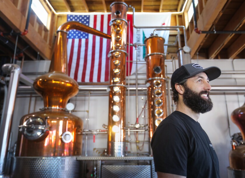 Nicholas Hammond, founder and head distiller at Pacific Coast Spirits in Oceanside, in front of his copper German-made Arnold Holstein still.