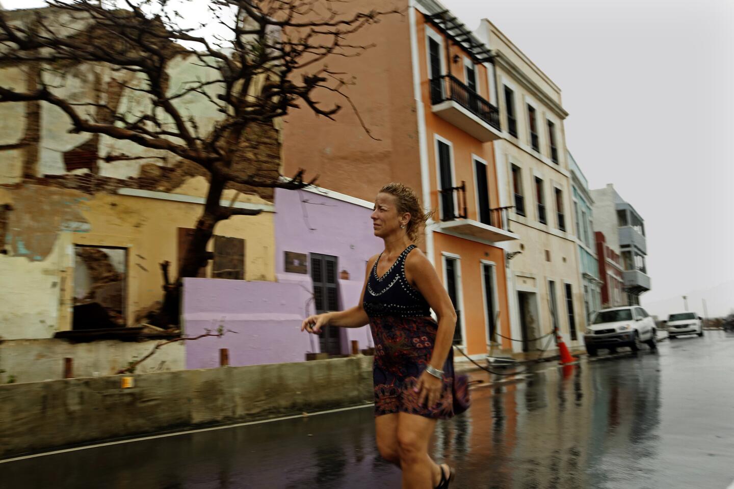 Old San Juan resident Rosa Avalo, 48, saw her home, purple building, damaged by debris from her neighbor's property.