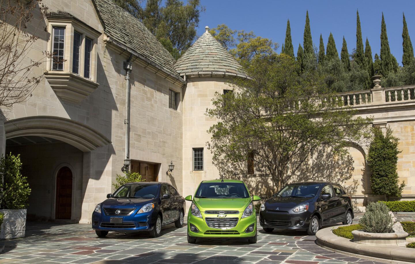 The Nissan Versa, left, Chevy Spark and Mitsubishi Mirage at the Greystone Mansion in Beverly Hills. These are the cars for people who want nothing more than the cheapest possible transportation, who view driving as a chore.