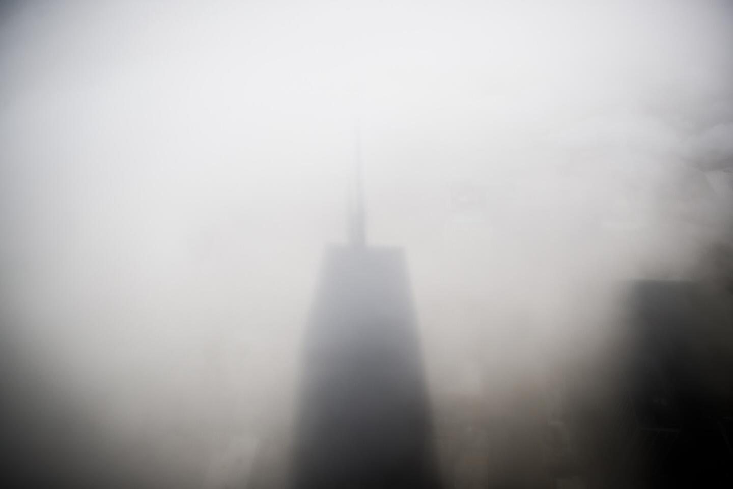 The John Hancock Center's shadow is cast on fog below the building Thursday June 6, 2019, in Chicago. (Armando L. Sanchez/Chicago Tribune)