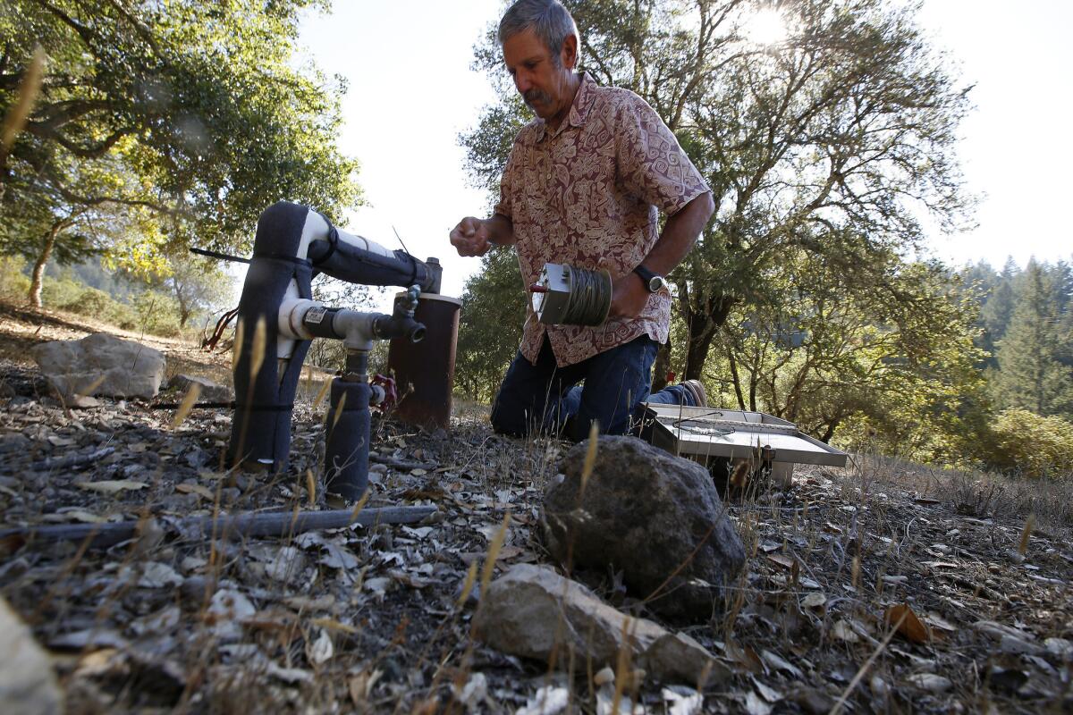 Ray Waldbaum checks the water level in the well at his home in the Mayacamas Mountains in Santa Rosa. The water level has dropped 10 feet since May.