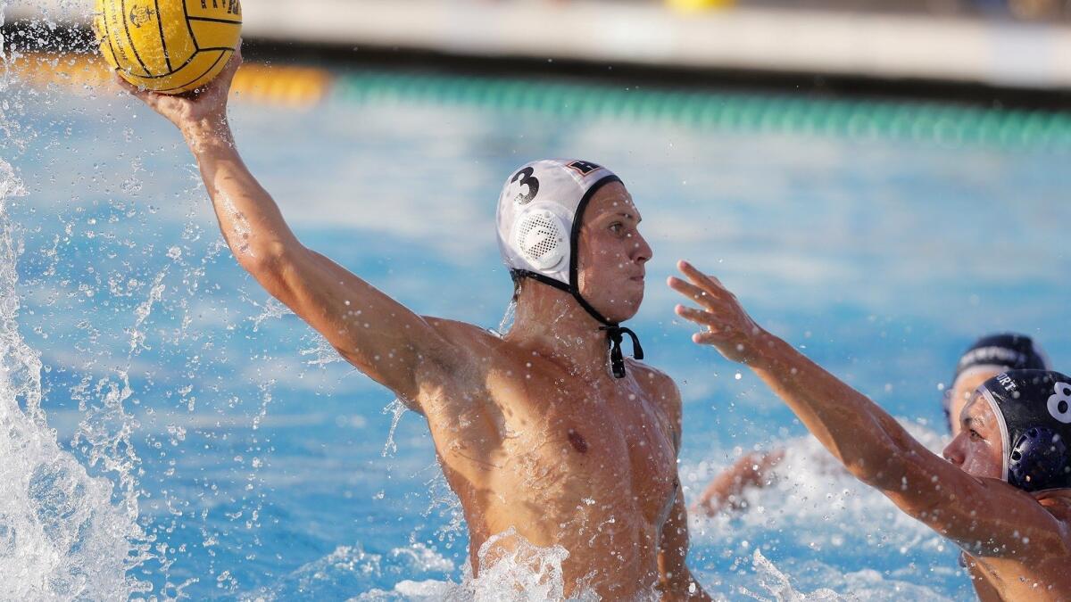 Huntington Beach High's Jack Green (3) scores one of his two goals while Newport Harbor's Reed Stemler (8) defends during the first half of a Surf League match on Wednesday.