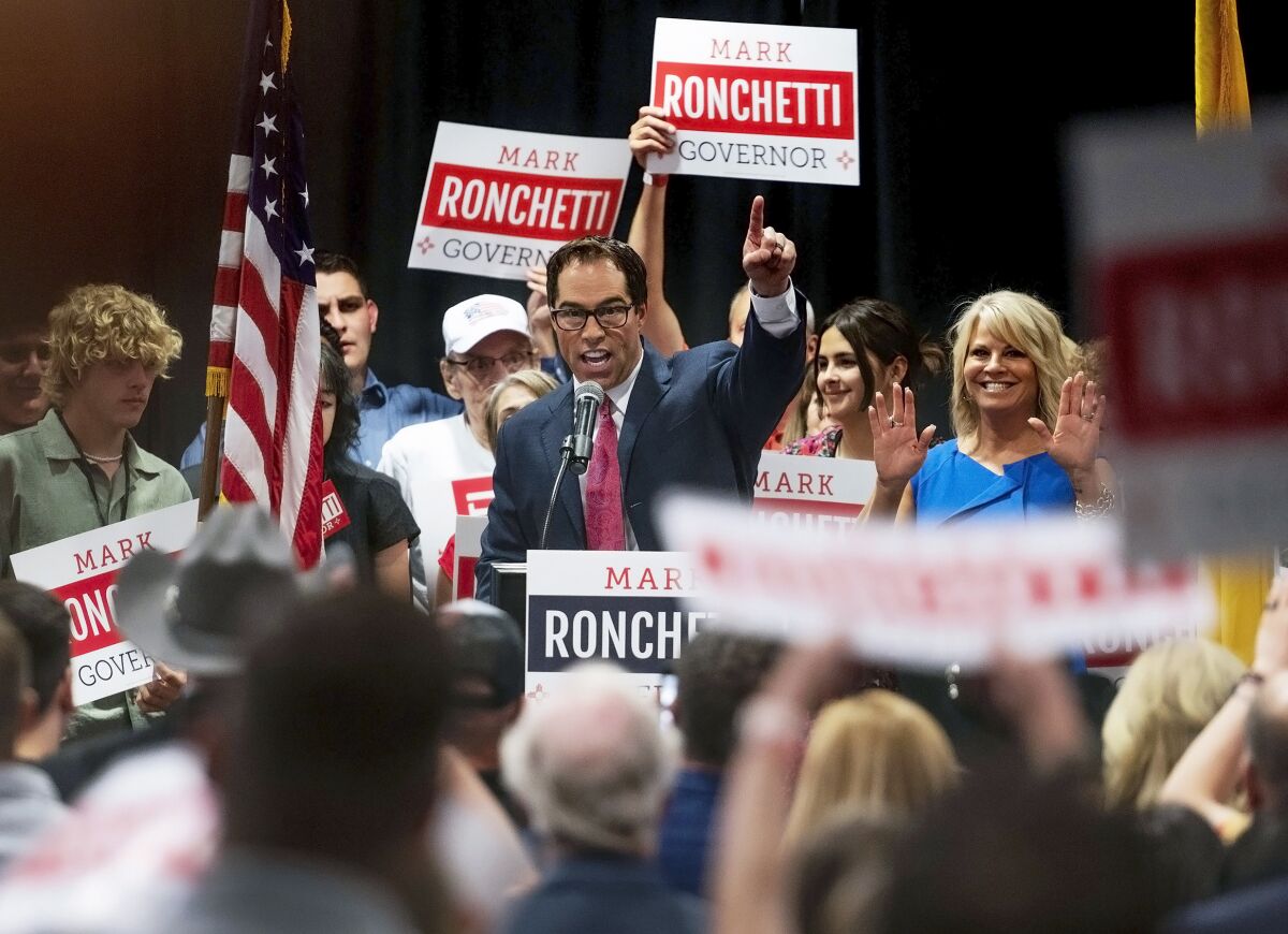 Republican Mark Ronchetti addresses the crowd with his wife and two daughters after winning the Republican primary for governor of New Mexico during an election party held at the Marriott in northeast Albuquerque, N.M., on Tuesday, June 7, 2022. Ronchetti was running against incumbent Democratic Gov. Michelle Lujan Grisham. (Chancey Bush/The Albuquerque Journal via AP)
