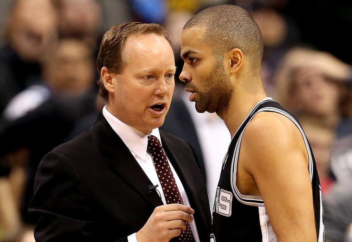 Mike Budenholzer, left, is seen with Tony Parker of the San Antonio Spurs.