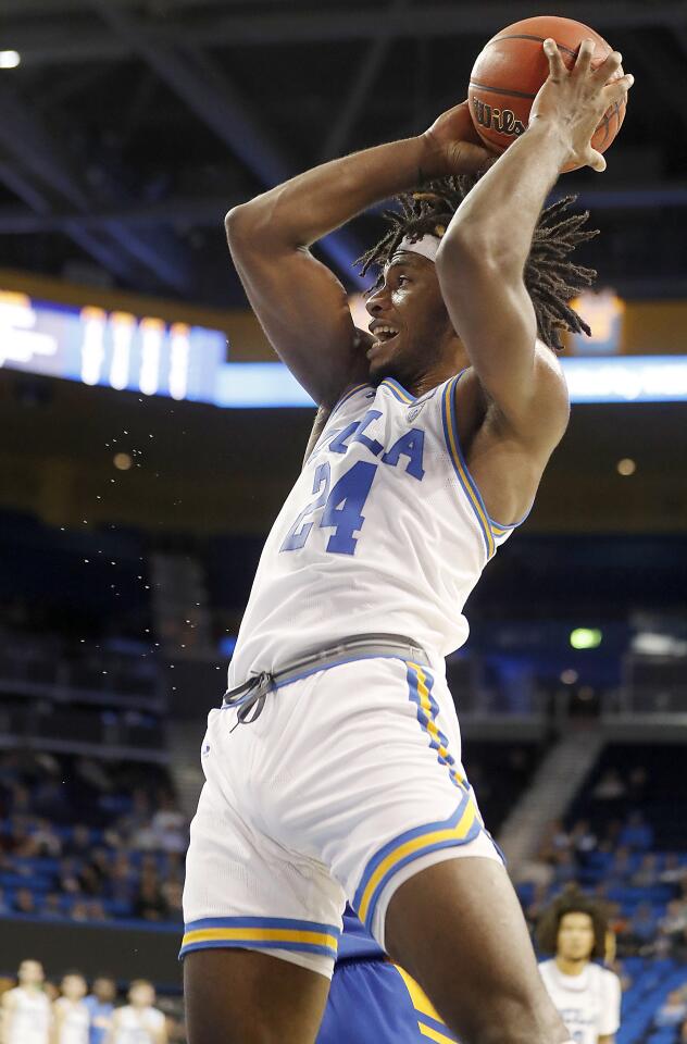 UCLA forward Jalen Hill pulls down an offensive rebound.