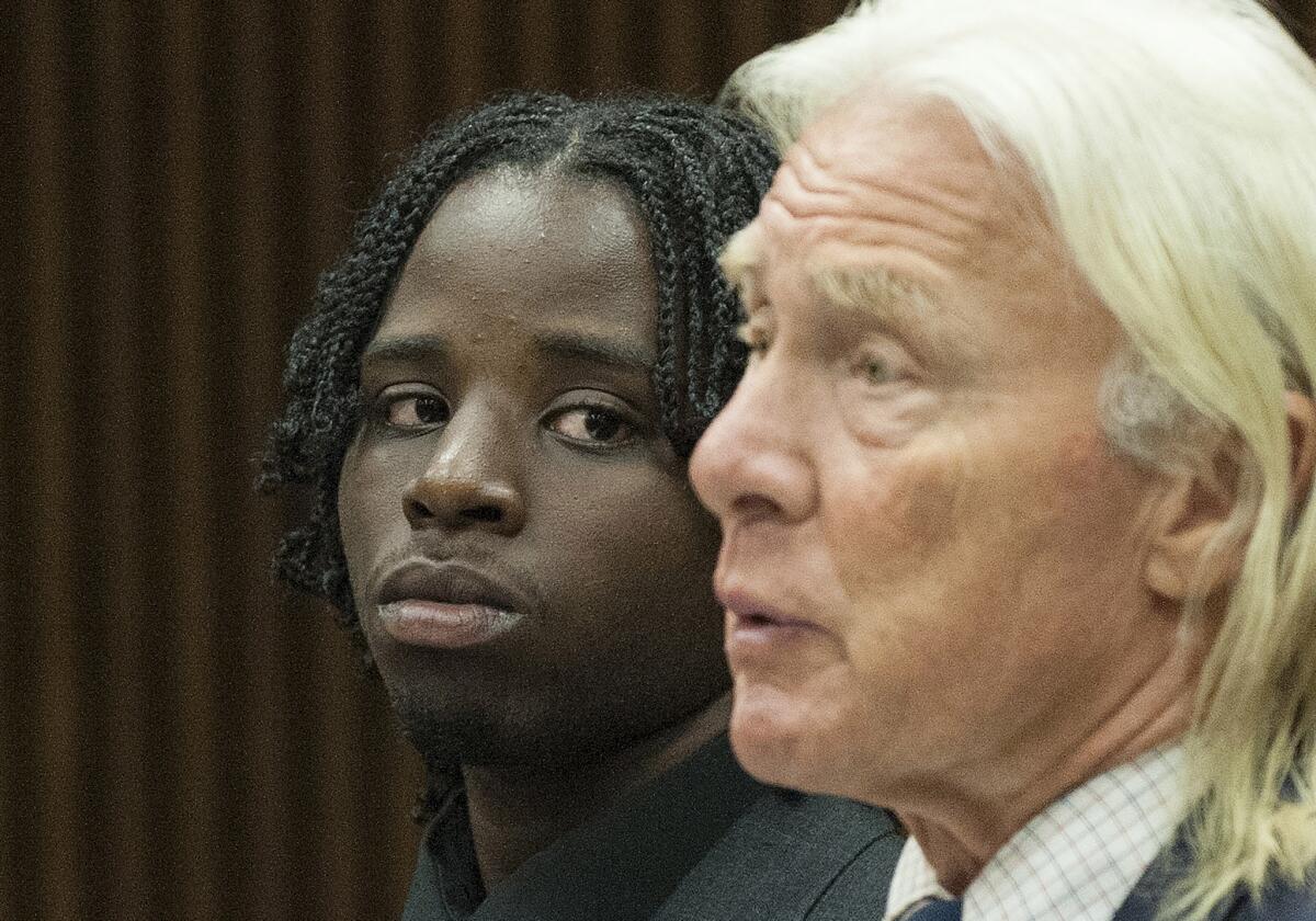 Latrez Cummings, left, is seen in court with attorney Robert Slameka on June 19, 2014.