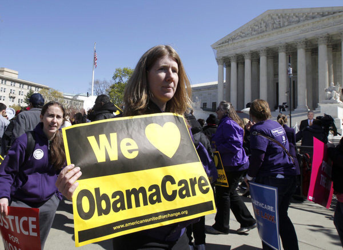 Supporters of healthcare reform rally in front of the Supreme Court in Washington.