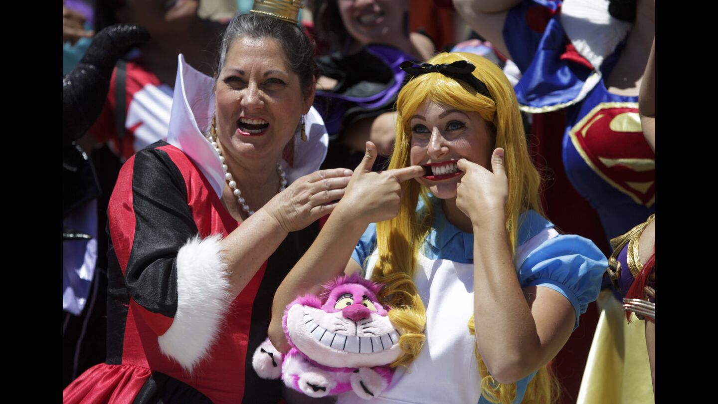 Jolynn Drott, left, and Kaylynn Wolfe pose for a picture during a Disney Princess meet-up on the second day of Comic-Con.