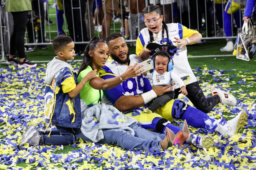 Inglewood, CA - February 13: Los Angeles Rams defensive end Aaron Donald (99) celebrates with his children after the Los Angeles Rams defeated Cincinnati Bengals 23-20 in Super Bowl LVI at SoFi Stadium on Sunday, Feb. 13, 2022 in Inglewood, CA.(Robert Gauthier / Los Angeles Times)