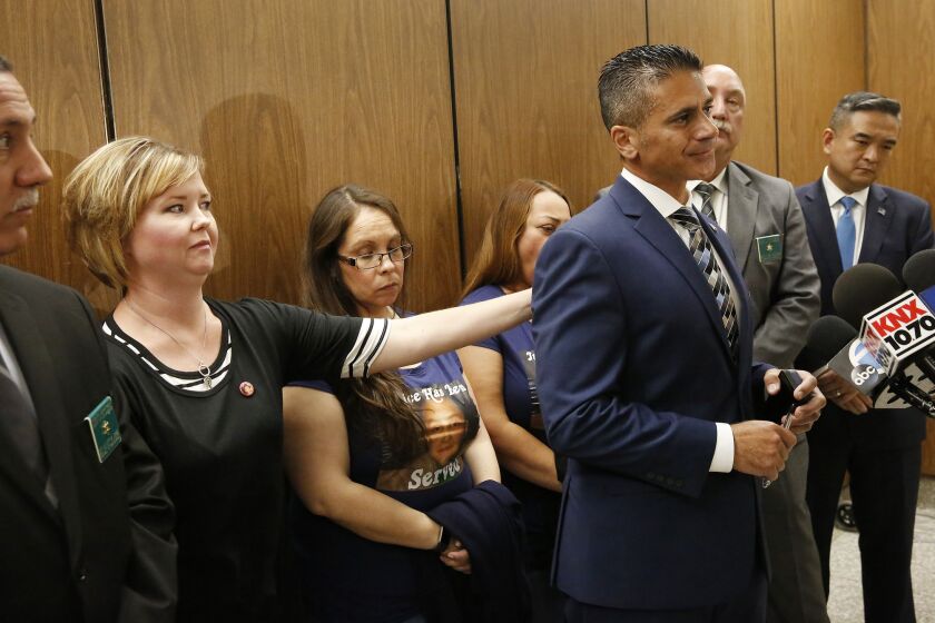 Jennifer Garcia, left, Gabriel's teacher who repeatedly reported signs of abuse, comforts Deputy Dist. Atty. Jonathan Hatami, who became emotional after the sentencing.