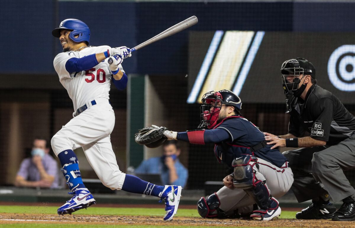 Dodgers right fielder Mookie Betts lines out during the third inning against the Braves.