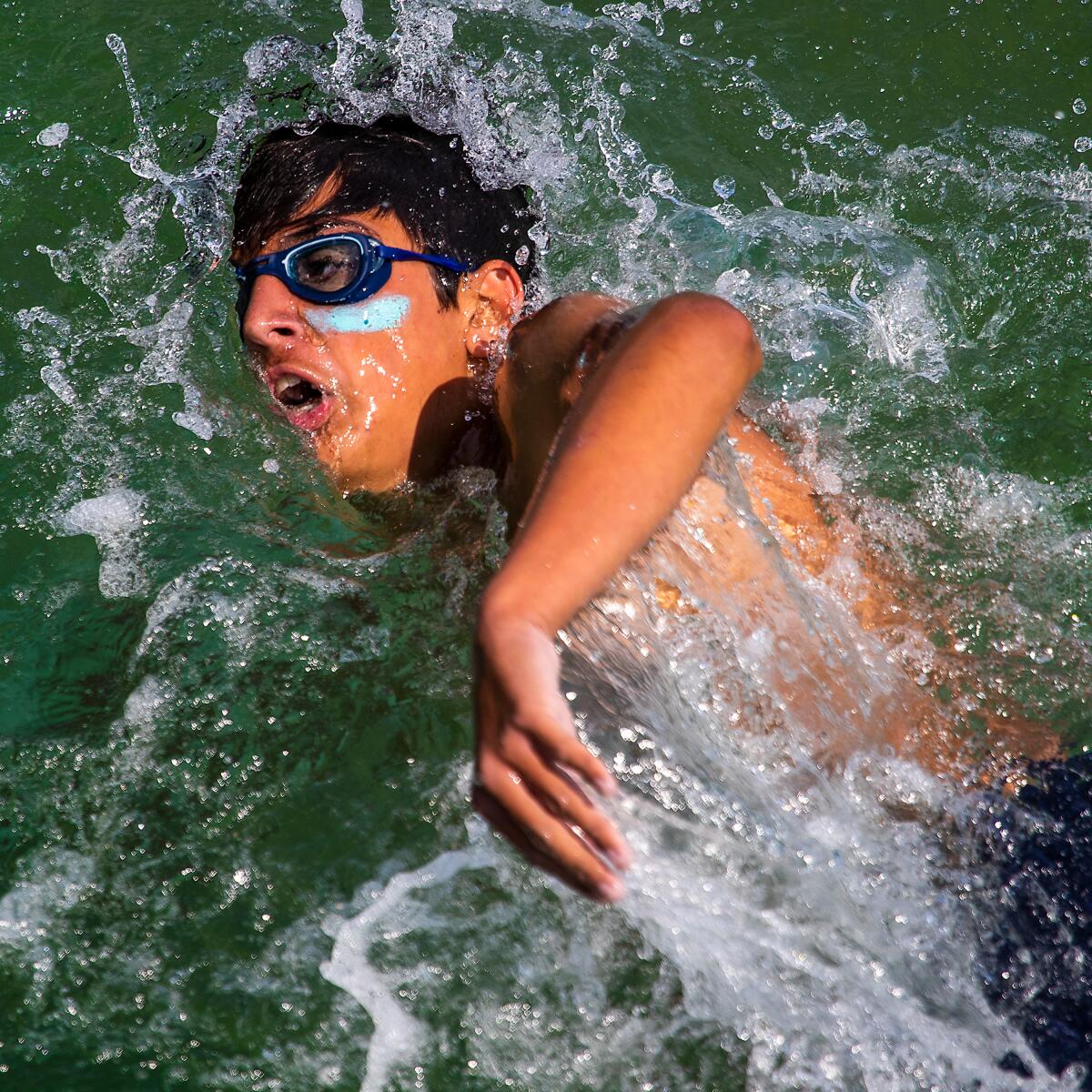 Los Angeles County Junior Lifeguard swims back to shore after jumping off the Hermosa Beach pier