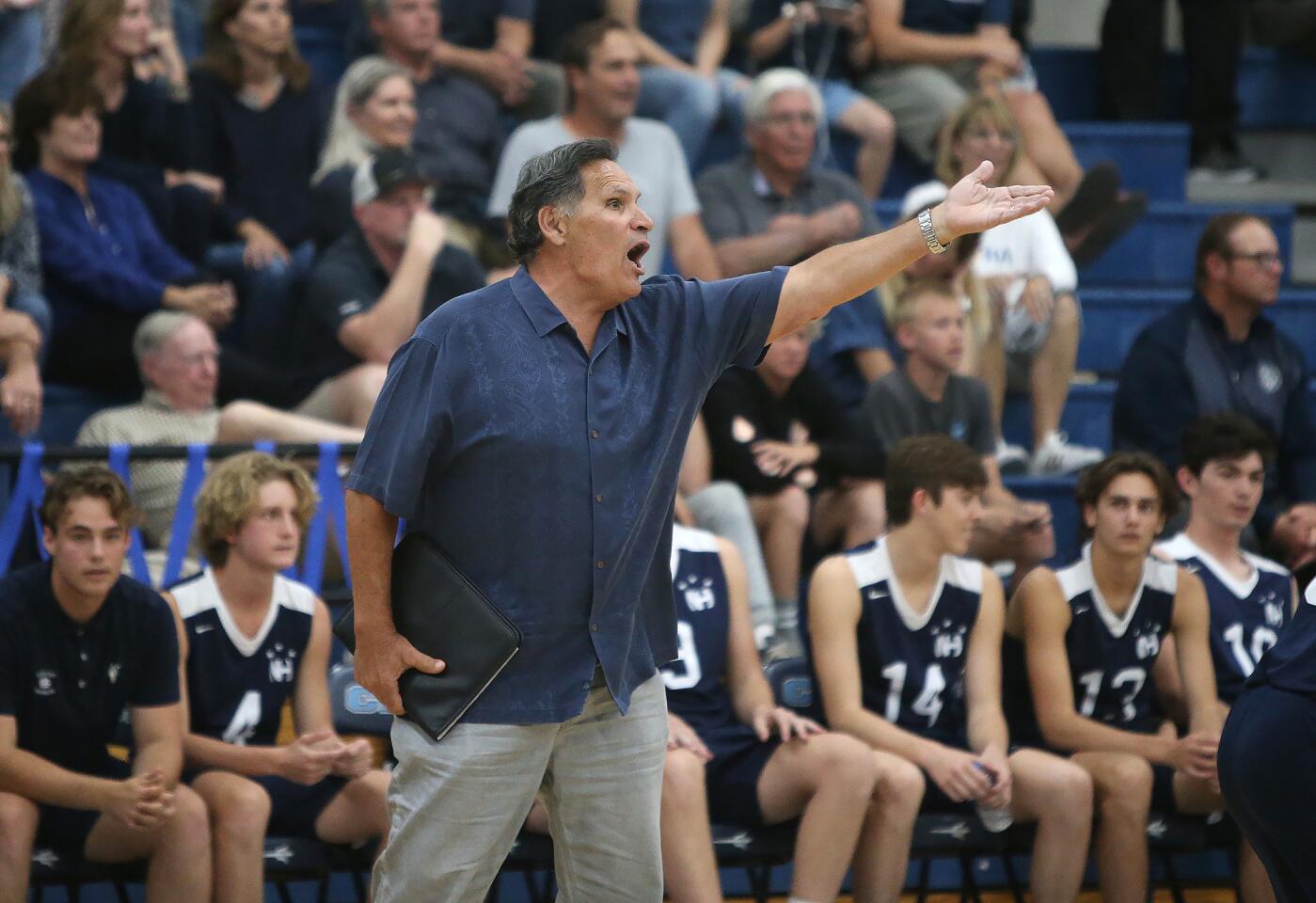 Newport Harbor coach Rocky Ciarelli argues against a call at the net during Battle of the Bay boys' volleyball match in Surf League play on Wednesday.