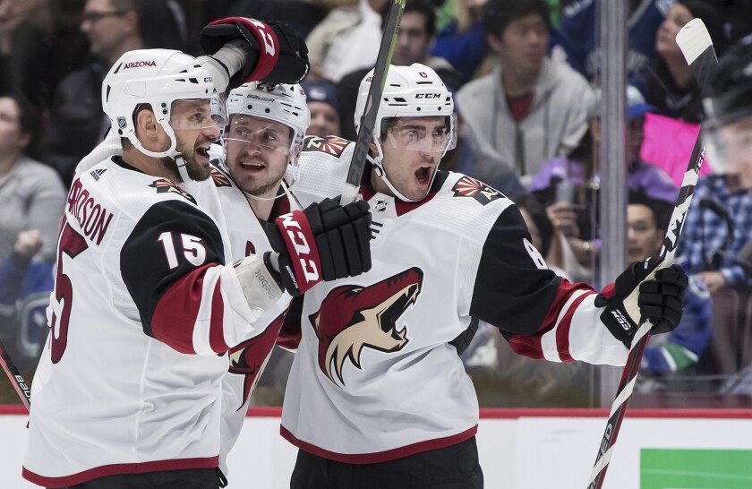 Arizona Coyotes' Brad Richardson, Oliver Ekman-Larsson and Nick Schmaltz, from left, celebrate Schmaltz's goal against the Vancouver Canucks during the third period on March 4 in Vancouver, Canada.