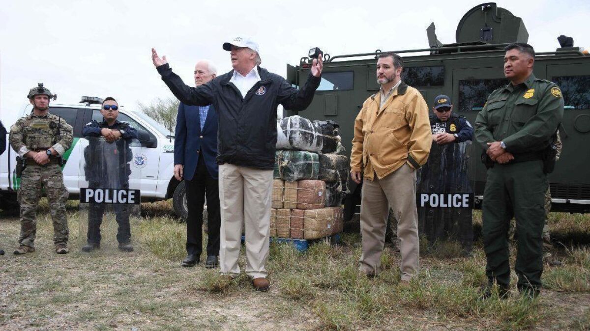 President Trump is flanked by Sens. Ted Cruz and John Cornyn and Border Patrol agents while speaking about the government shutdown and his proposal for a wall in McAllen, Texas, on Jan. 10.