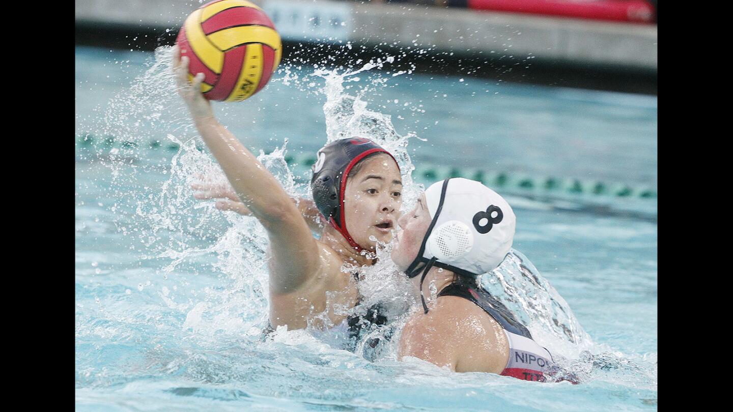 Burroughs' Gwendolyn Turla receives a fast break pass from the Burroughs goalie to turn, shoot and score against Nipomo's Claire Wellencamp in a first round CIF division VI girls' water polo match at Burroughs High School on Tuesday, February 13, 2018. Burroughs won the match.