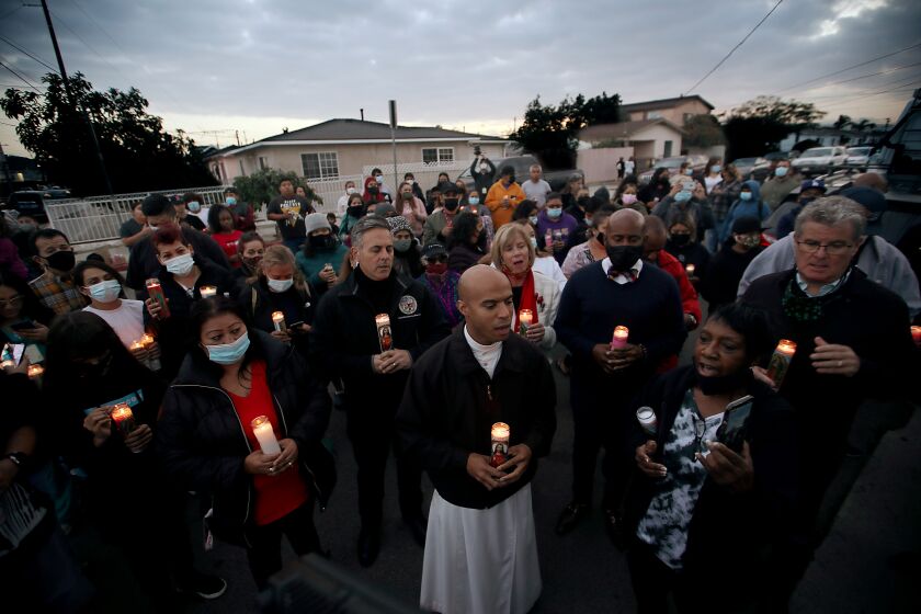 LOS ANGELES, CALIF. - DEC. 7, 2021. Elected officials join residents of Wilmington in a candlelight vigil for three people who were shot near the intersection of Blinn Avenue and L Street on Moday, Dec. 6, 2021. A 13-year-old boy was killed in the shooting, and a nine-year-old girl was injured. Police asked for the community's help in tracking down the perpetrator. (Luis Sinco / Los Angeles Times)