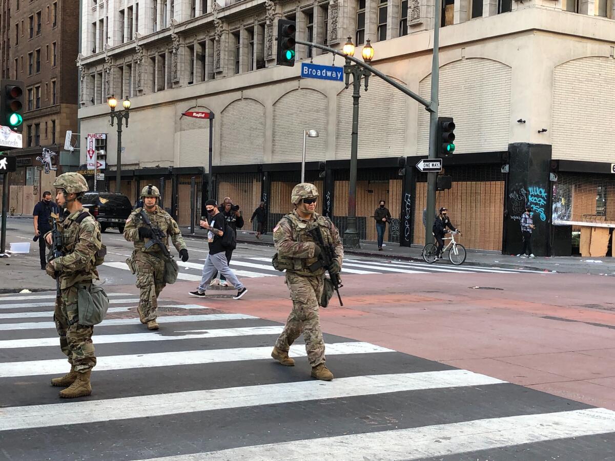 National Guard troops patrol downtown Los Angeles on Sunday.