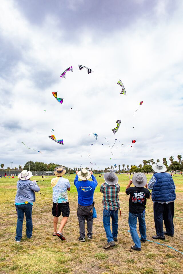 Ruth Lawson, Don Fox, Tom King, Mark Quirmbach, Russell Dickison and Vernon White (from left) fly in formation at the OB Kite Festival.