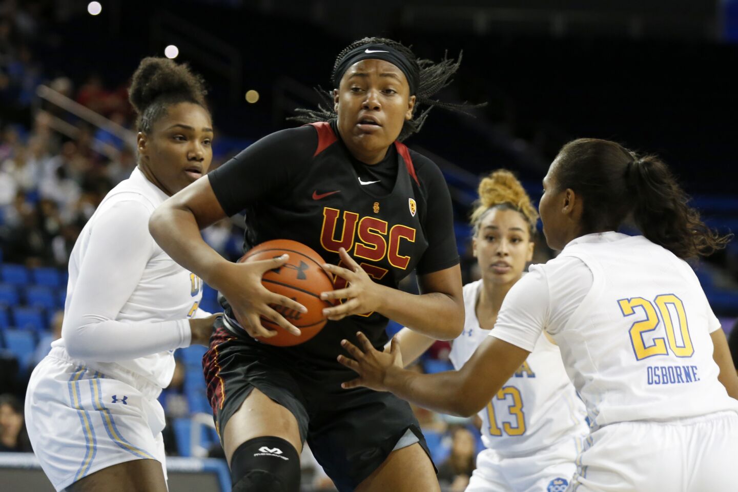 USC center Angel Jackson drives to the basket past UCLA guard Charisma Osborne (20) during the first half.