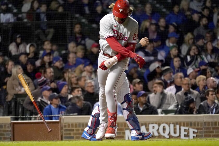 Philadelphia Phillies' Alec Bohm slams his bat to the ground after flying out to end the top half of the fifth inning of a baseball game against the Chicago Cubs Wednesday, Sept. 28, 2022, in Chicago. (AP Photo/Charles Rex Arbogast)