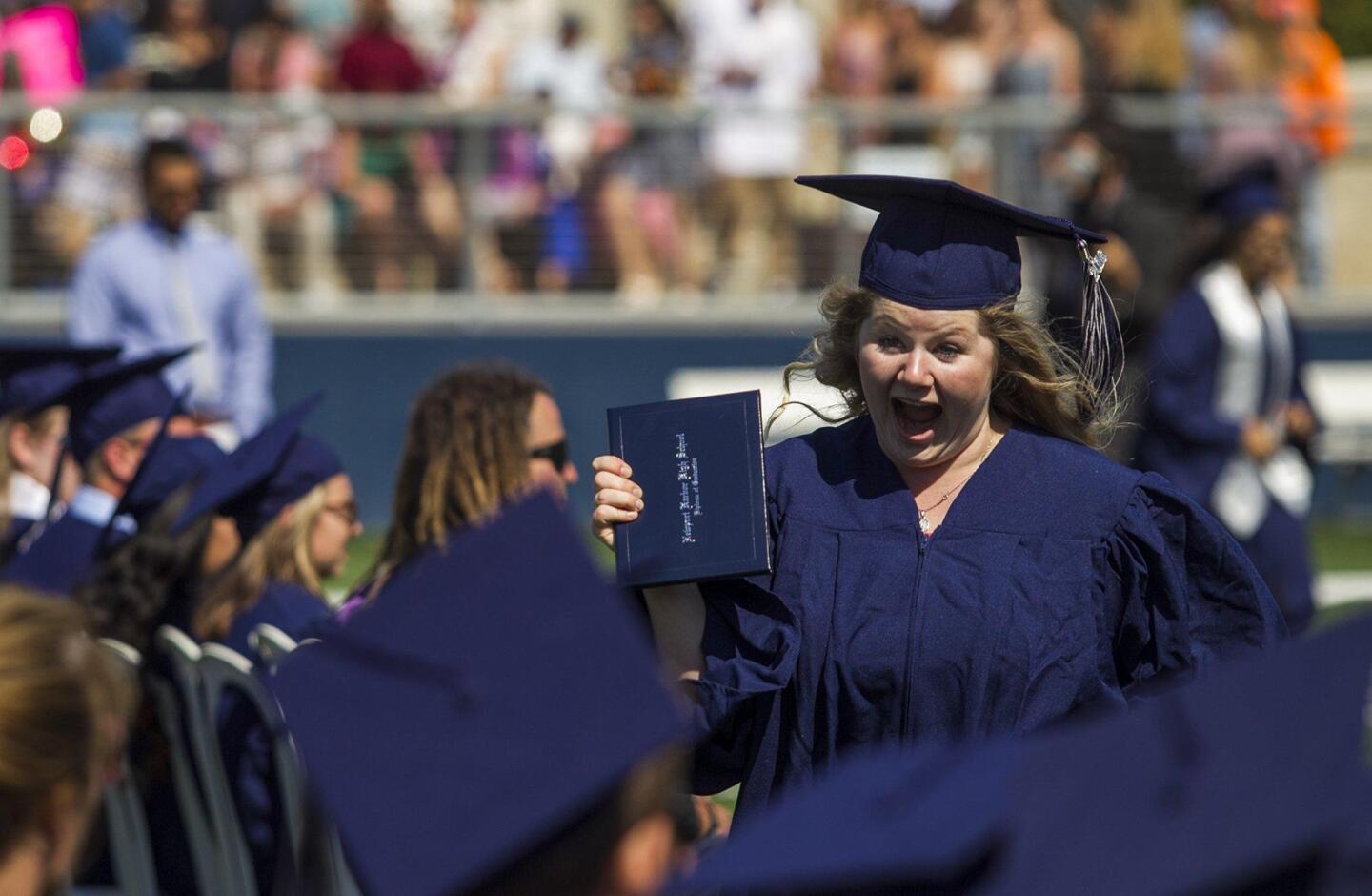 Kaylee Call shows off her diploma during the 2016 commencement ceremony for Newport Harbor High School at Orange Coast College on Thursday.