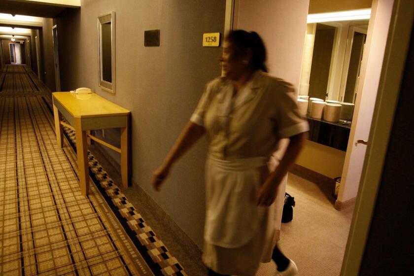 LOS ANGELES, CALIF. - DECEMBER 22, 2011: Maria Jimenez, a housekeeper, closes a door on the 12th floor of the Wilshire Grand Hotel in downtown Los Angeles on December 22, 2011. She has workedat the hotel 30 years. The Wilshire Grand Hotel in downtown Los Angeles is closing Friday after 59 years. It will be demolished and replaced by a $1.1 billion hotel and office complex. (Gary Friedman/Los Angeles Times)